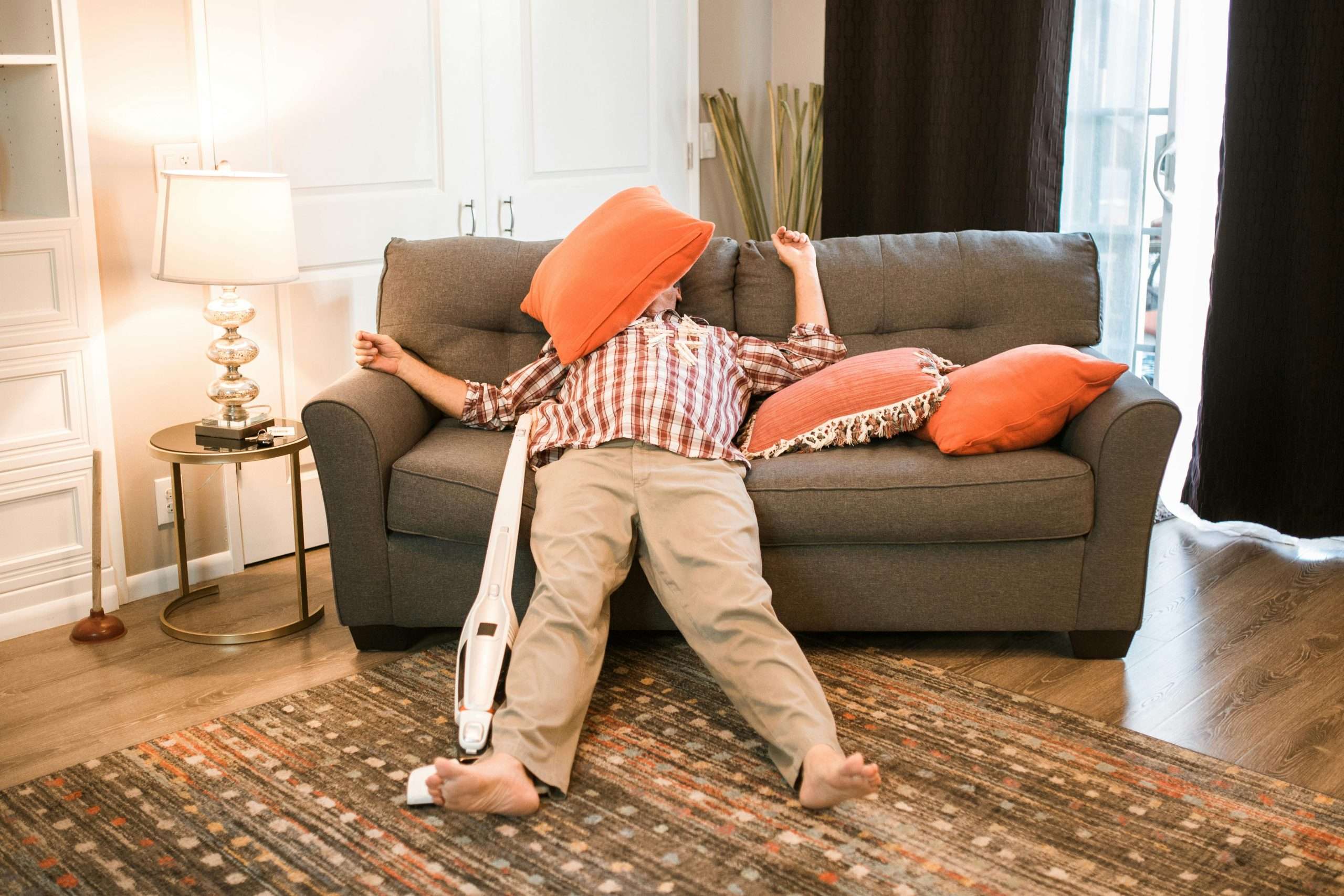 A man lounging around his house instead of getting things done.